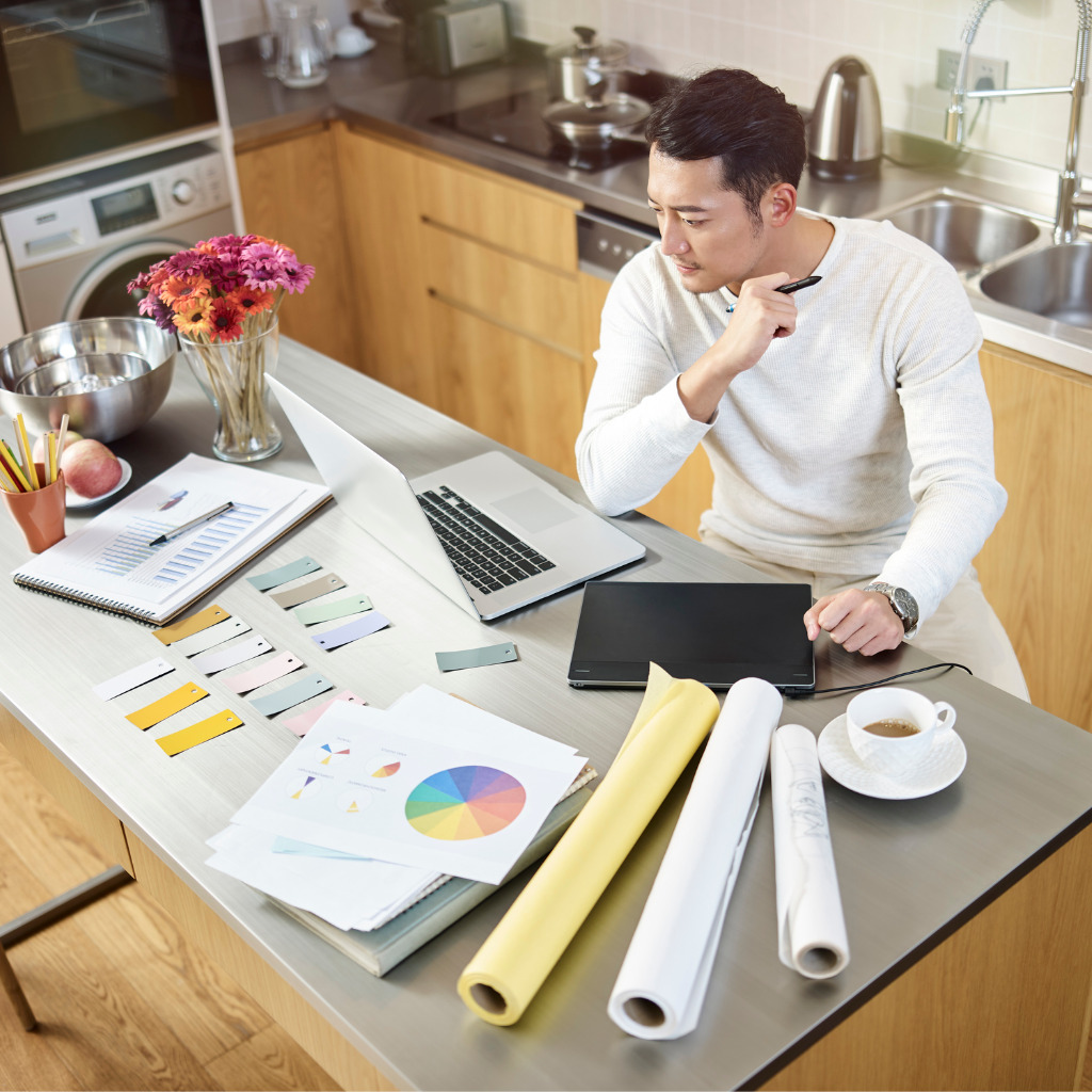 image of man working from home on kitchen island